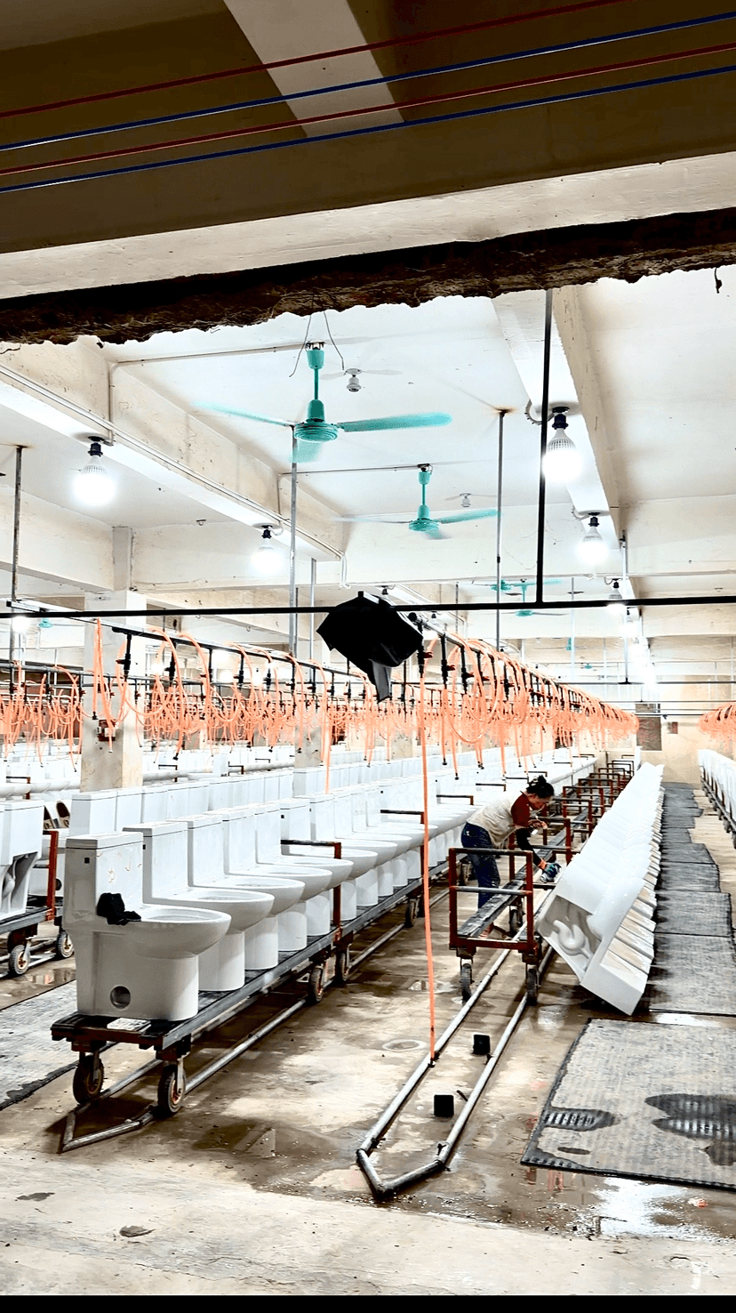 Completed ceramic toilets on the production floor of a partner manufacturer